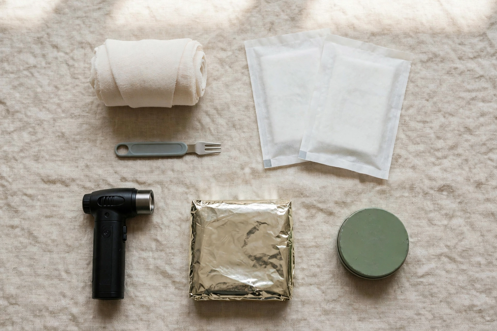 Dog travel first aid kit laid out: bandages, tick remover, wipes, torch and paw balm